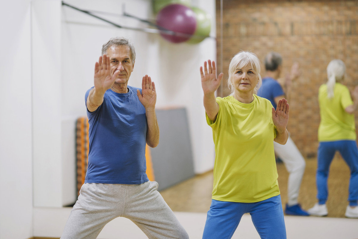 pilates seniors retired couple doing exercises