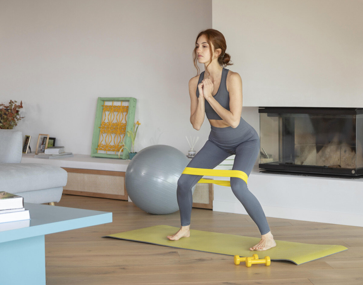 exploring world pilates equipment woman doing fitness home with band