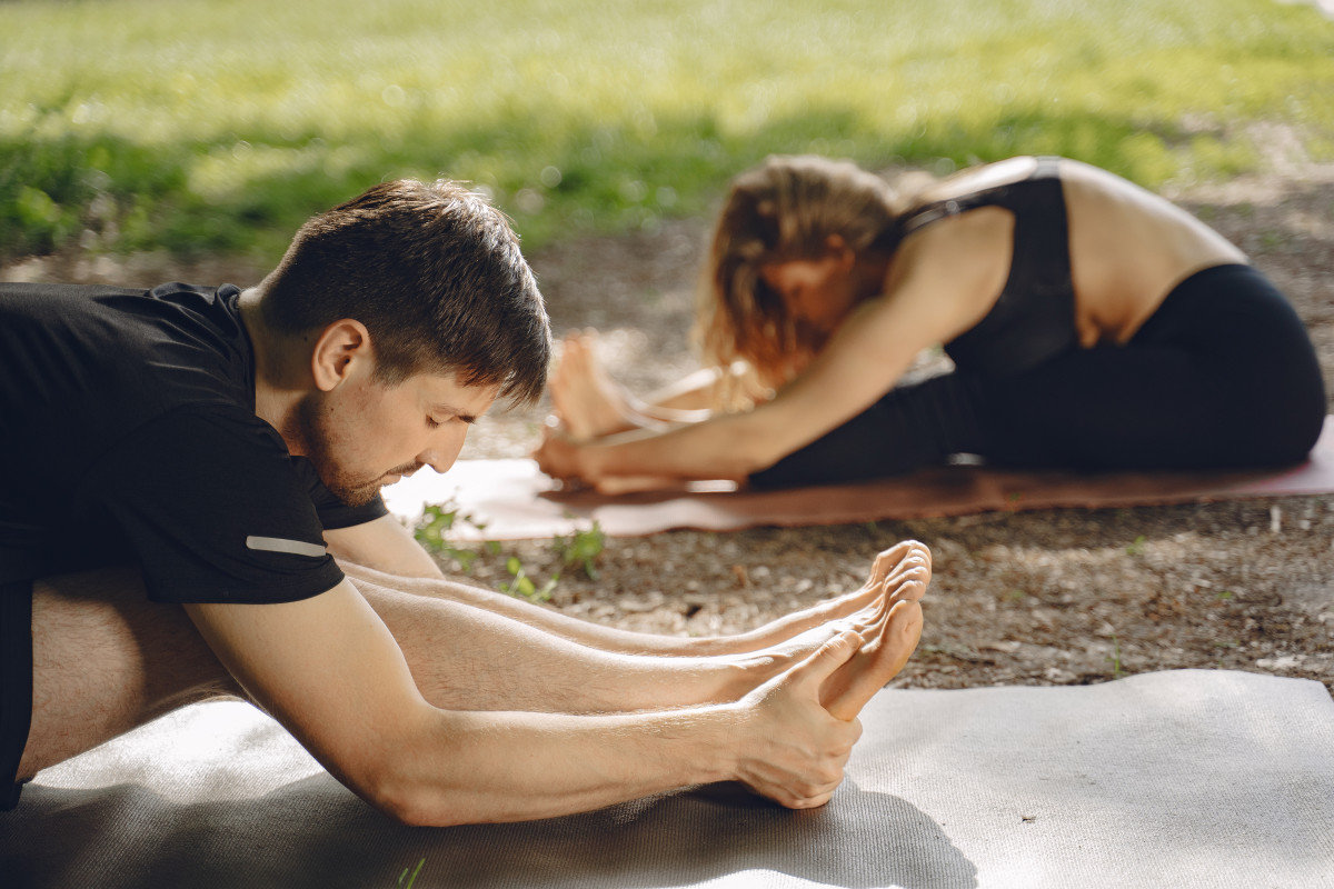 holistic fitness approac couple doing yoga fitness people summer park