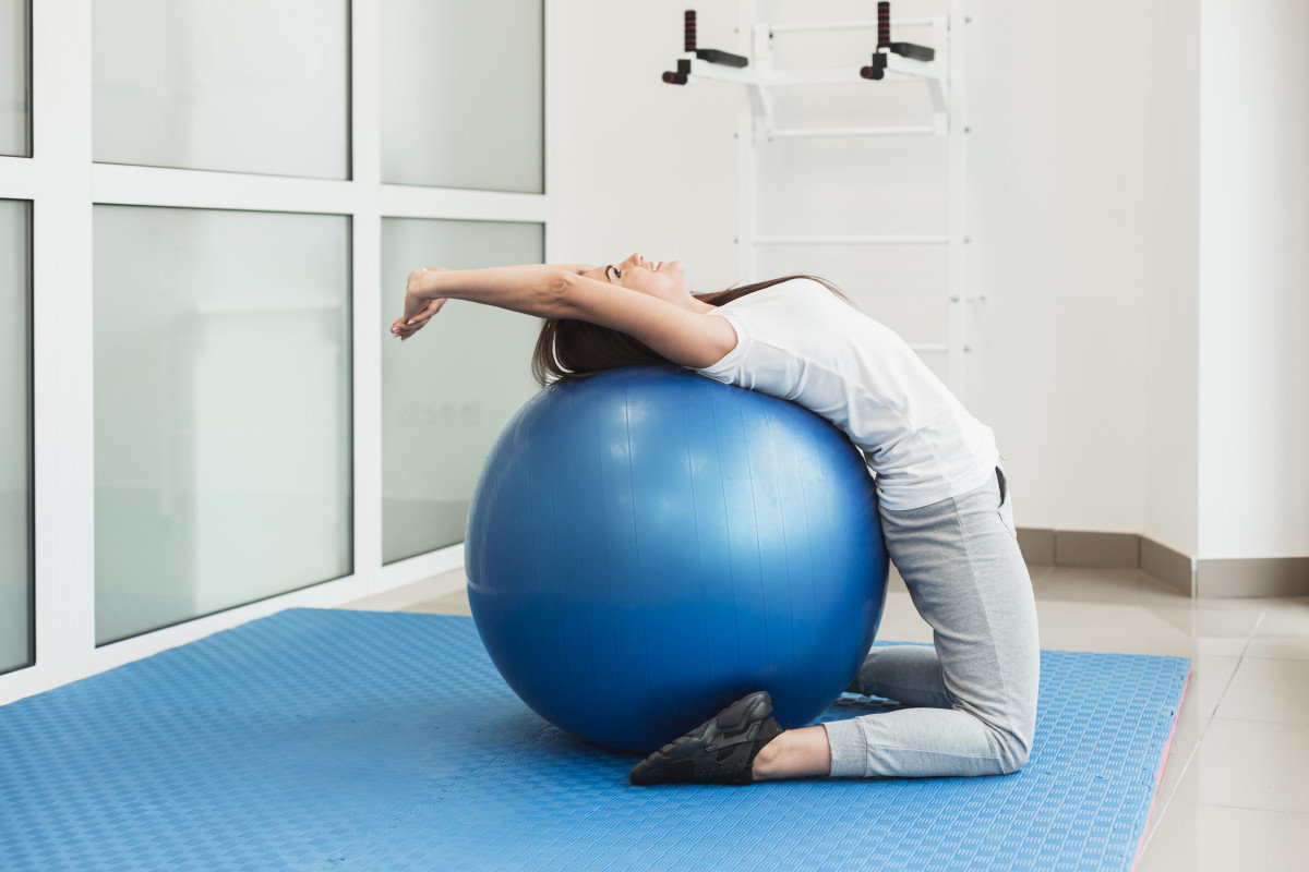 pilates back pain female patient using exercise ball