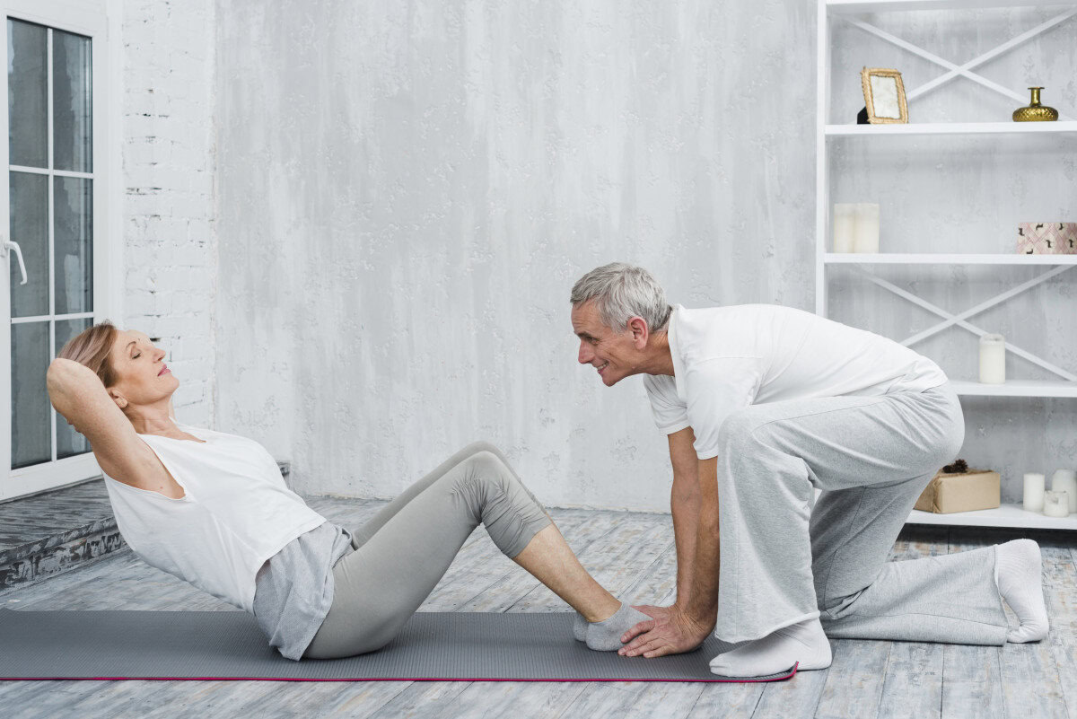 pilates aging gracefully couple pose exercise mat