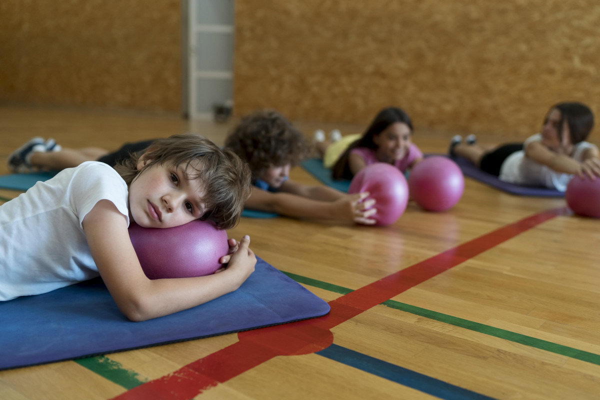 pilates kids laying yoga mats happy concentration