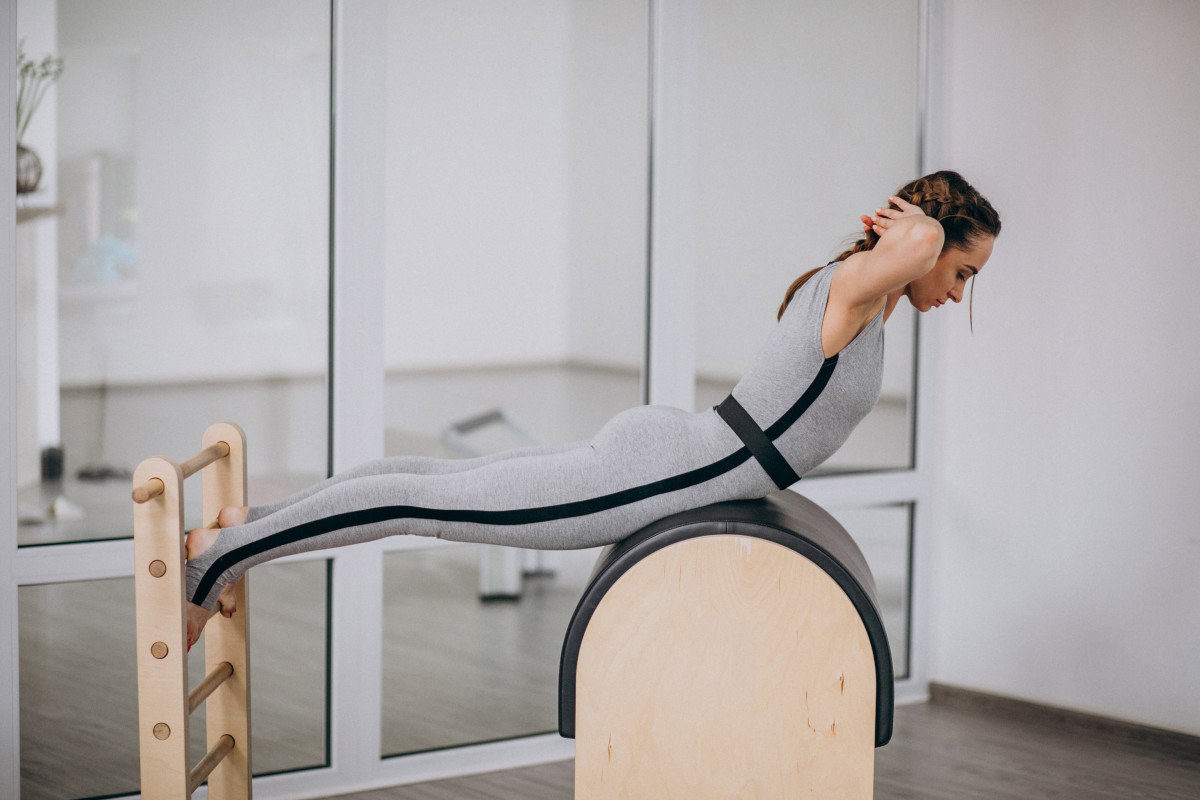 pilates woman practising barrel alignment breathing muscles
