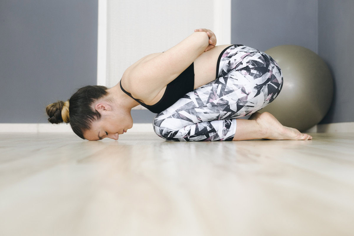 woman pilates exercising floor balance mind focus